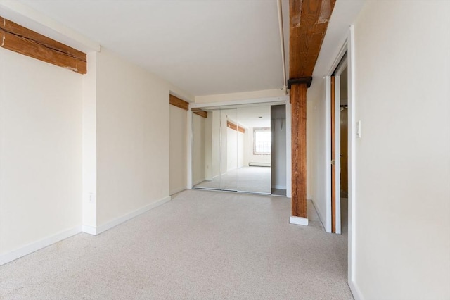 hall featuring baseboards and carpet flooring