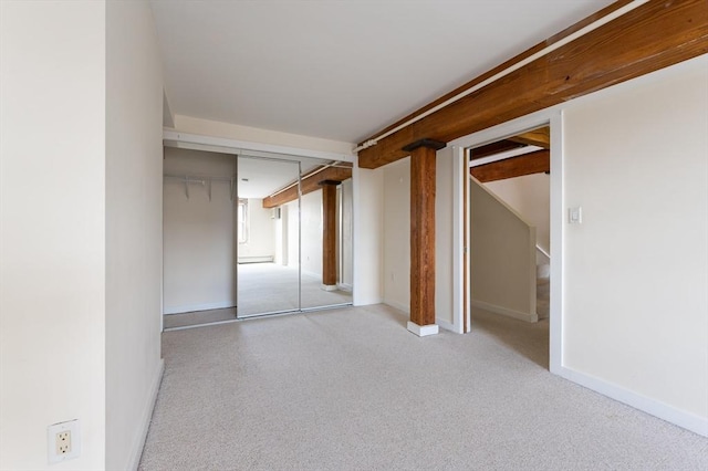 hallway with a baseboard heating unit, baseboards, carpet floors, and stairs