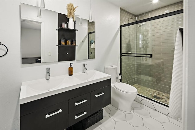 50 Triton Ave, Winthrop, MA 02152 - bathroom featuring toilet, double vanity, a stall shower, and tile patterned floors