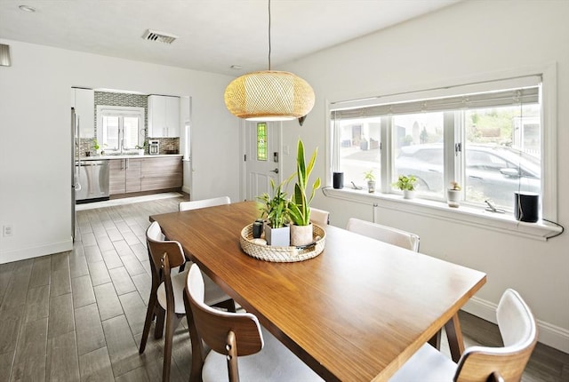 50 Triton Ave, Winthrop, MA 02152 - dining area with baseboards and dark wood-type flooring