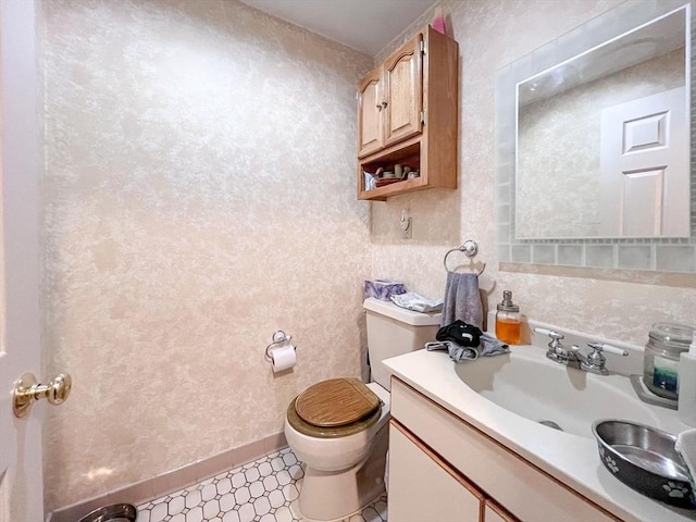 bathroom featuring vanity and toilet