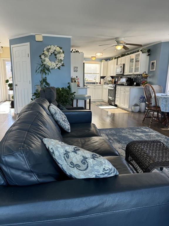 living room featuring ceiling fan and wood finished floors