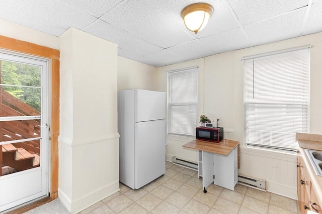 342 Broadway, North Attleboro, MA 02760 - kitchen featuring freestanding refrigerator, black microwave, a baseboard radiator, a paneled ceiling, and light flooring