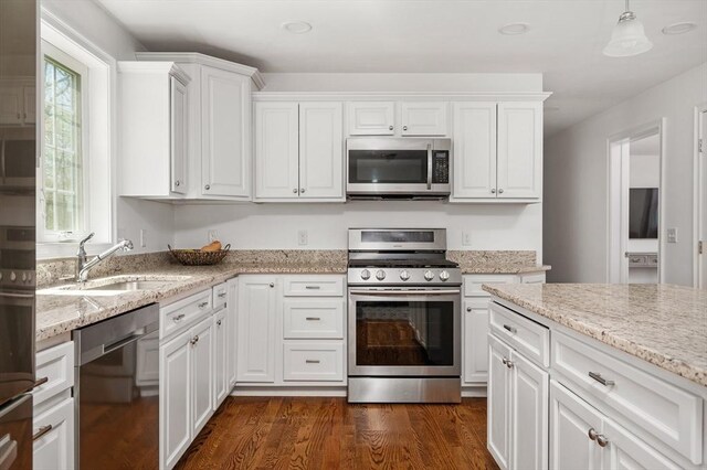kitchen featuring white cabinetry, appliances with stainless steel finishes, a sink, and dark wood-type flooring