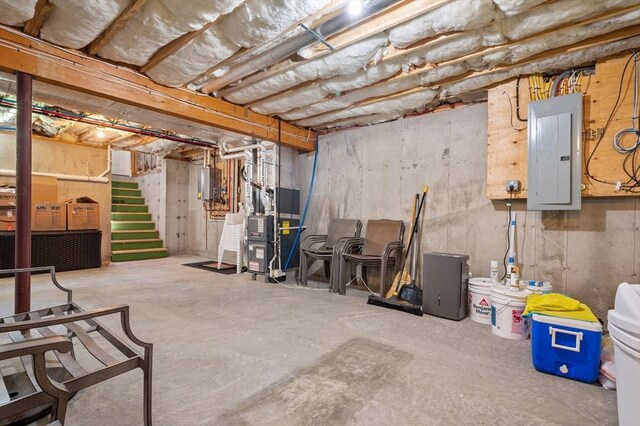 unfinished basement featuring heating unit and electric panel