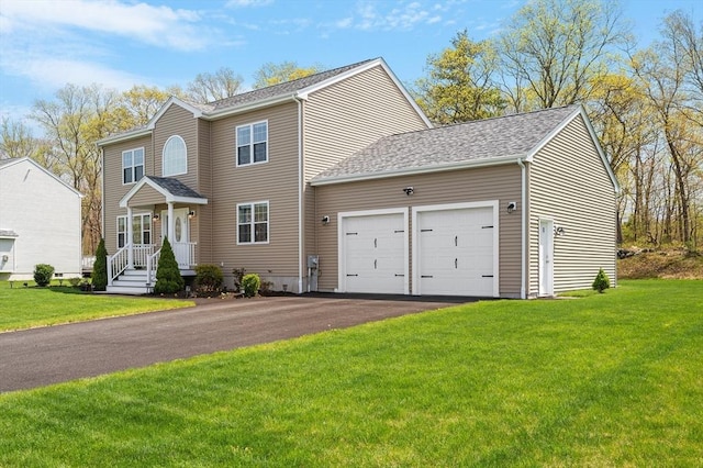 view of front facade with a garage, aphalt driveway, roof with shingles, and a front yard