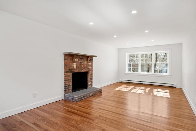 unfurnished living room featuring a baseboard radiator, a fireplace, light wood-style flooring, and baseboards