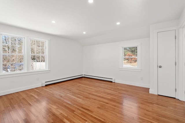 unfurnished bedroom with light wood-style floors, a baseboard radiator, vaulted ceiling, and recessed lighting