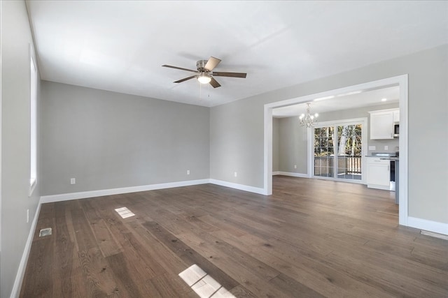 unfurnished living room with dark hardwood / wood-style floors and ceiling fan with notable chandelier