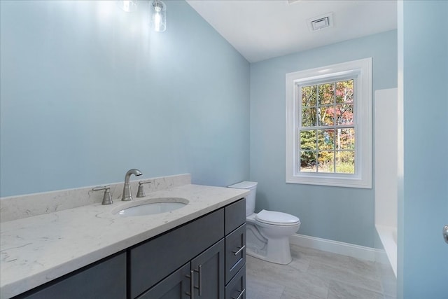 bathroom with a tub to relax in, vanity, and toilet