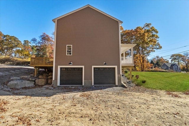 view of side of property with a lawn and a garage