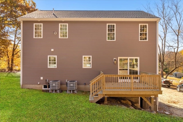 rear view of house featuring a wooden deck, a yard, and central AC unit