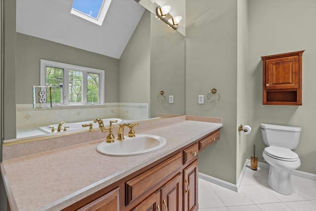 bathroom with a skylight, toilet, vanity, tile patterned floors, and high vaulted ceiling