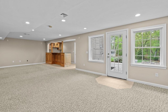 entryway featuring baseboards, light colored carpet, and recessed lighting