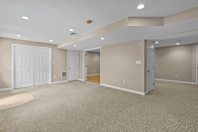 finished basement featuring carpet floors, baseboards, and recessed lighting