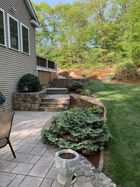 view of green lawn featuring stairway and a patio area