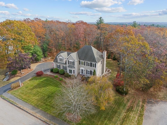 view of subject property featuring a heavily wooded area