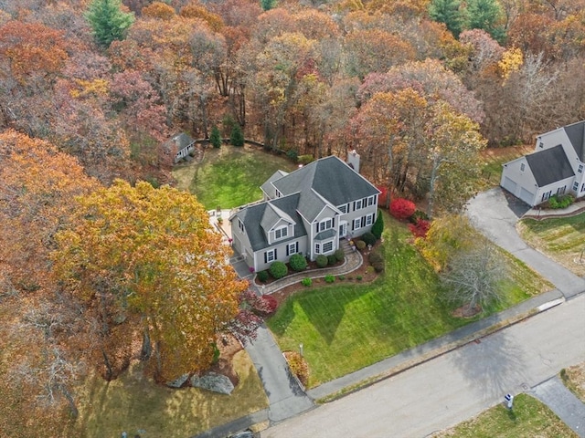 view of subject property with a heavily wooded area