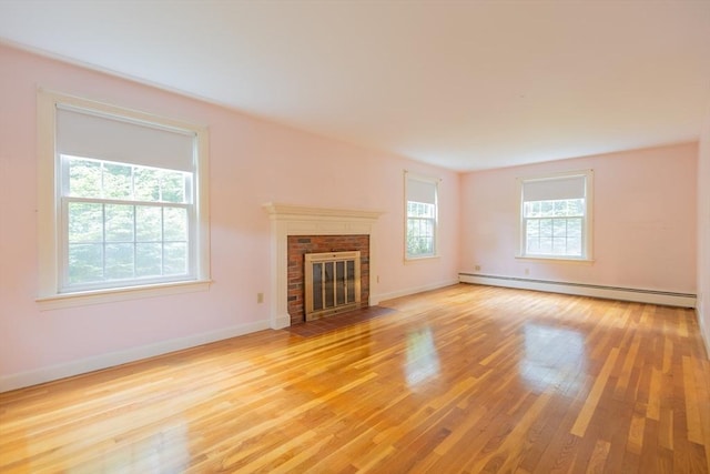 22 Liberty St, Bellingham, MA 02019 - unfurnished living room featuring a baseboard radiator, light wood-style flooring, and a fireplace