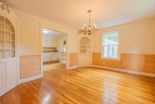 22 Liberty St, Bellingham, MA 02019 - unfurnished dining area with light wood-style floors, a chandelier, and a wainscoted wall