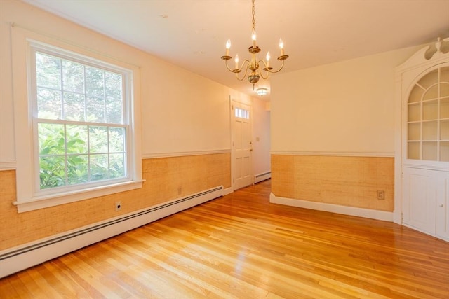 22 Liberty St, Bellingham, MA 02019 - spare room with a baseboard heating unit, a chandelier, light wood finished floors, and wainscoting