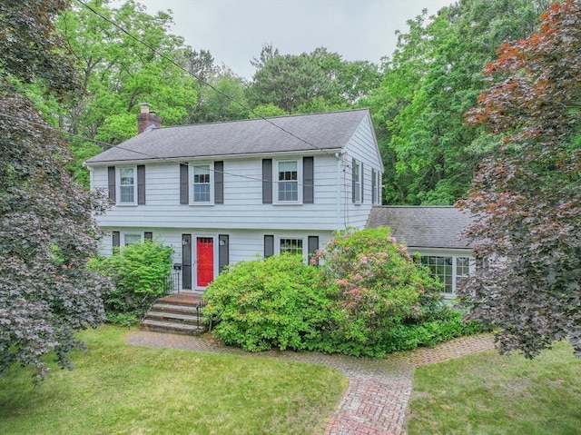 22 Liberty St, Bellingham, MA 02019 - colonial home featuring a chimney, a front yard, and roof with shingles