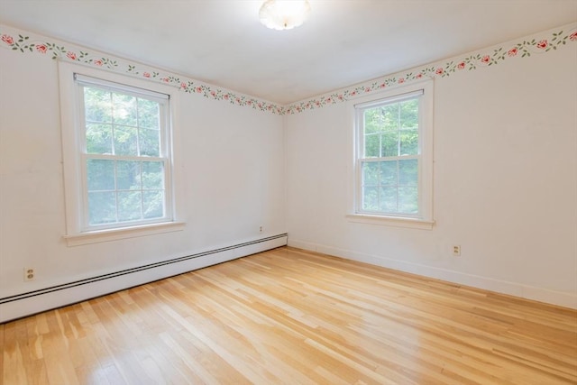 22 Liberty St, Bellingham, MA 02019 - unfurnished room with a baseboard heating unit and wood finished floors