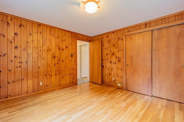 22 Liberty St, Bellingham, MA 02019 - unfurnished bedroom featuring wood finished floors, a closet, and wooden walls