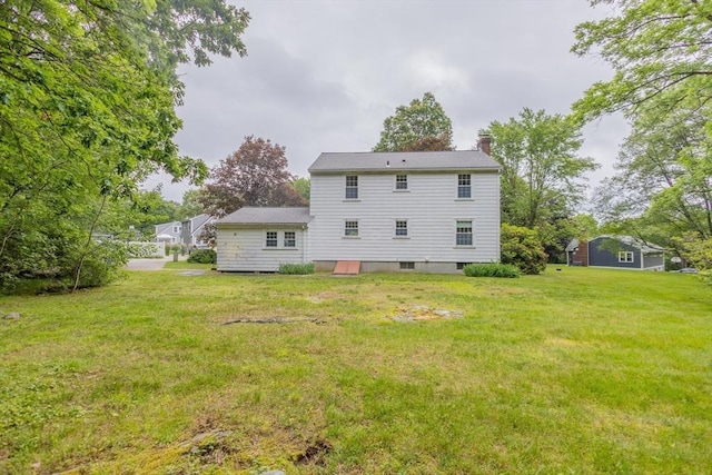 22 Liberty St, Bellingham, MA 02019 - rear view of house with a chimney and a yard