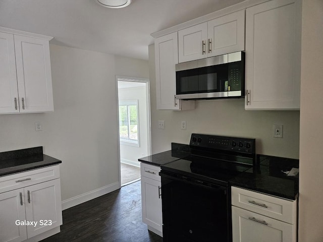 461 N Orange Rd, Athol, MA 01331 - kitchen with stainless steel microwave, black range with electric stovetop, dark wood-style floors, white cabinets, and dark countertops