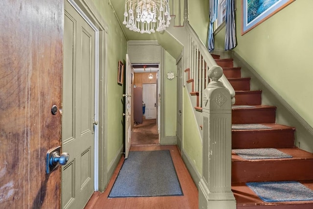 439 Walnut Ave, Boston, MA 02119 - staircase featuring a chandelier and baseboards
