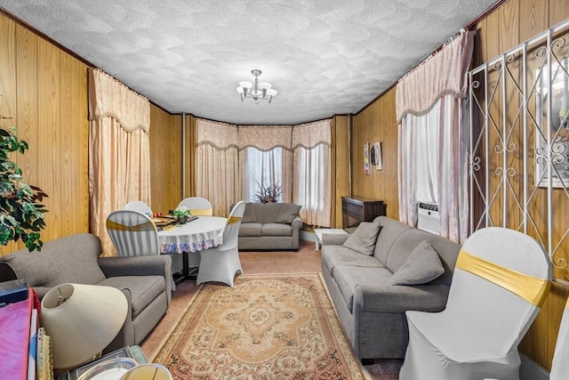 439 Walnut Ave, Boston, MA 02119 - carpeted living room with wooden walls, a chandelier, and a textured ceiling