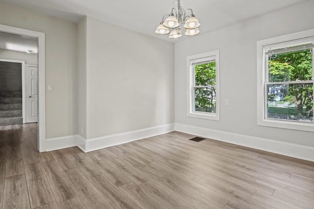 10 Jackson St, Ayer, MA 01432 - unfurnished room with a chandelier, wood finished floors, and baseboards