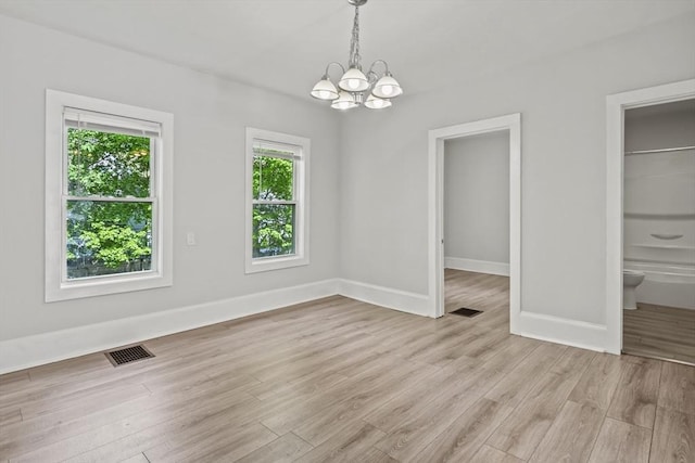 10 Jackson St, Ayer, MA 01432 - unfurnished dining area featuring a chandelier, light wood-type flooring, and baseboards