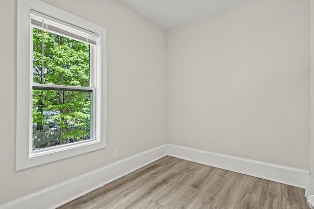 10 Jackson St, Ayer, MA 01432 - empty room featuring wood finished floors, plenty of natural light, and baseboards