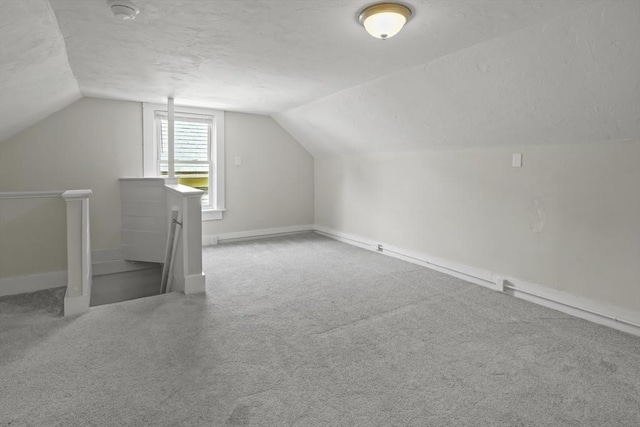 10 Jackson St, Ayer, MA 01432 - bonus room with vaulted ceiling, a textured ceiling, baseboards, and carpet