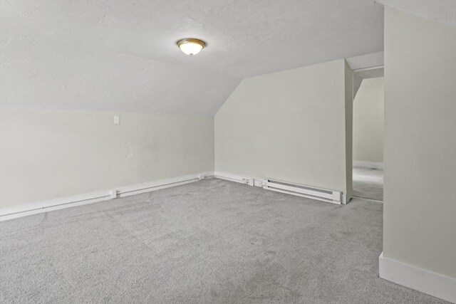 10 Jackson St, Ayer, MA 01432 - additional living space featuring a baseboard radiator, carpet floors, lofted ceiling, a textured ceiling, and baseboards