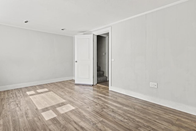 10 Jackson St, Ayer, MA 01432 - empty room featuring wood finished floors, stairway, and baseboards