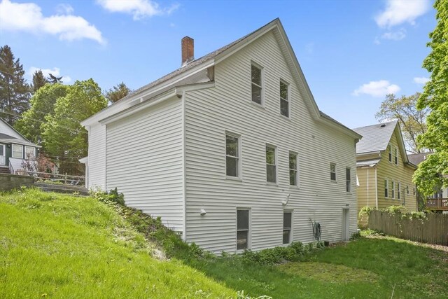 10 Jackson St, Ayer, MA 01432 - view of home's exterior featuring a chimney and fence