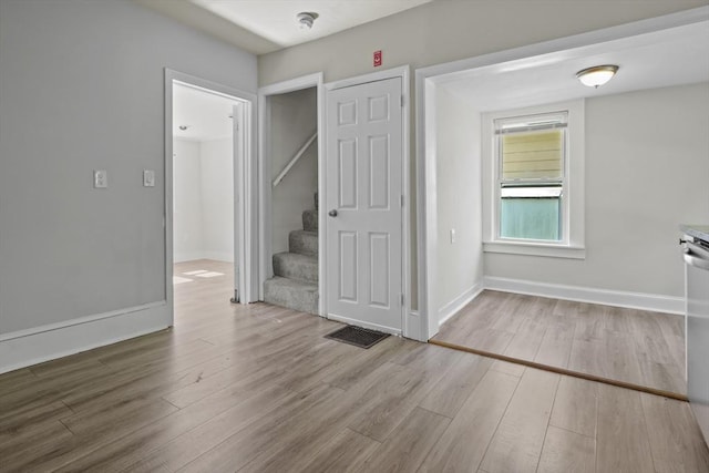 10 Jackson St, Ayer, MA 01432 - unfurnished dining area with wood finished floors, stairs, and baseboards