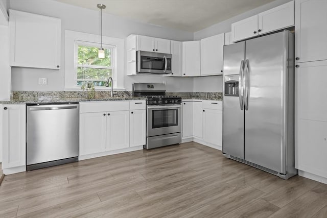10 Jackson St, Ayer, MA 01432 - kitchen with appliances with stainless steel finishes, a sink, stone counters, white cabinetry, and light wood finished floors