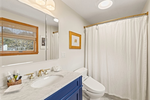 bathroom featuring toilet, a shower with curtain, and vanity