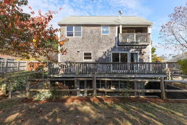 rear view of house featuring a deck and a balcony