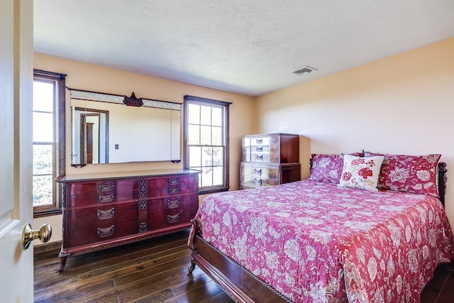 bedroom featuring dark hardwood / wood-style flooring