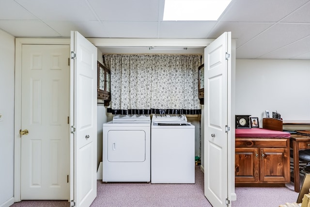 laundry area featuring washing machine and dryer and light colored carpet