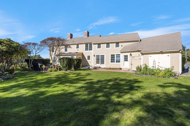 rear view of house featuring a patio and a yard