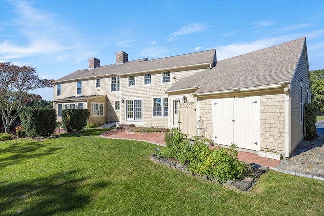 rear view of property featuring a yard and a patio