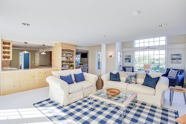 carpeted living room featuring sink