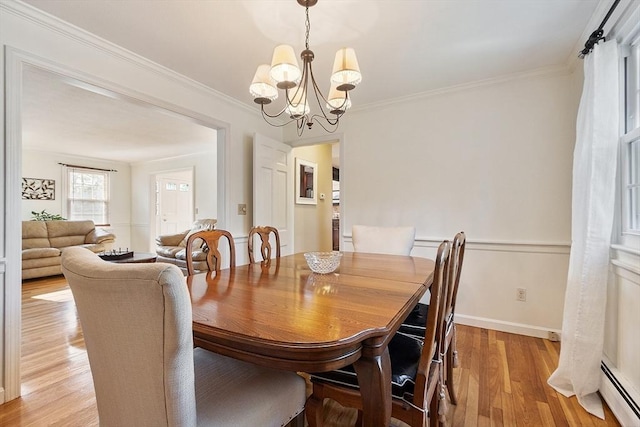 16 Kirsi Cir, Westford, MA 01886 - dining space with a baseboard radiator, a chandelier, light wood-style floors, crown molding, and baseboards