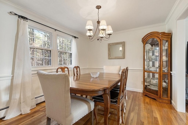16 Kirsi Cir, Westford, MA 01886 - dining space with a chandelier, crown molding, light wood finished floors, and baseboards